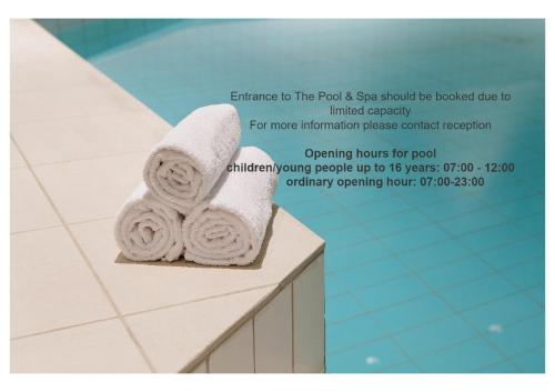 a stack of towels sitting on a counter in a bathroom at Scandic Royal Stavanger in Stavanger