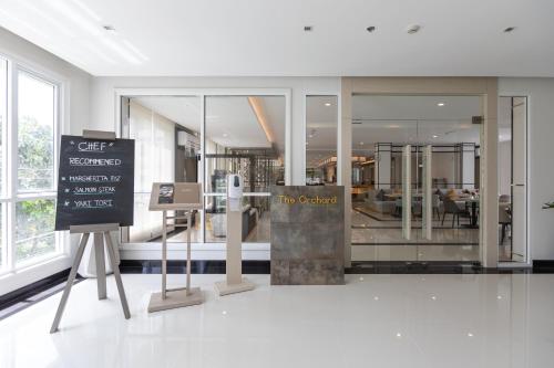 a lobby with a sign in the middle of a building at Kantary Hotel Banchang in Ban Chang