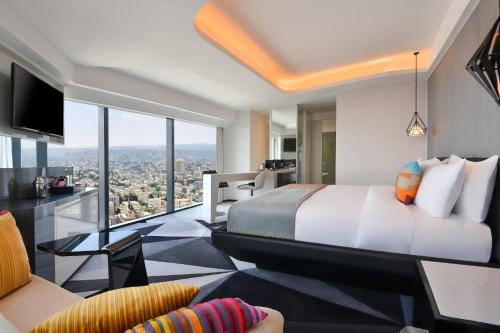 a hotel room with a bed and a view at W Amman Hotel in Amman