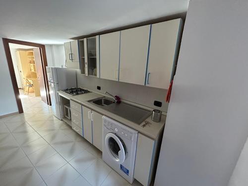 a kitchen with a sink and a washing machine at LB Guest House in Tagliacozzo