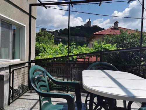 a patio with a table and chairs on a balcony at Mira Home in Veliko Tŭrnovo