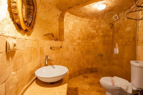 a bathroom with a toilet and a sink and a shower at Atilla's Cave Hotel in Nevsehir