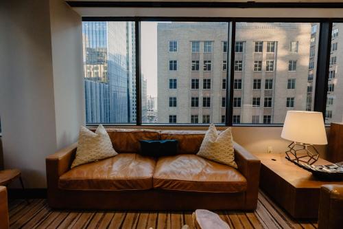 a leather couch in a room with a large window at JW Marriott Houston Downtown in Houston