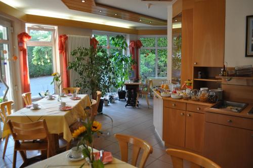a kitchen with a table and chairs in a room at Pension Keller in Reichenau