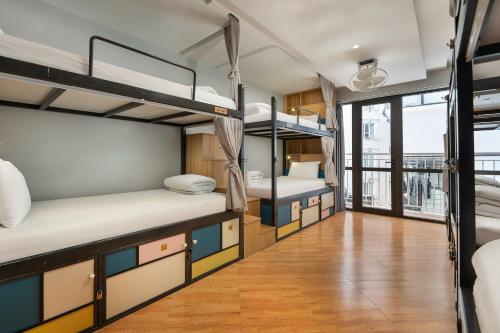 a dorm room with bunk beds and a wooden floor at Old Quarter View Hanoi Hostel in Hanoi