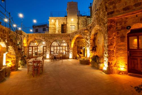 an old stone building with a patio at night at Atilla's Cave Hotel in Nevsehir