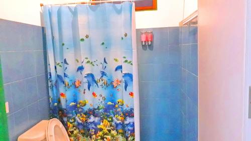 a shower curtain in a bathroom with flowers and butterflies at Swiss Chalet Garden, Pool Resort in Krabi town