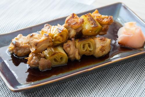 a plate of food with chicken wings and sauce at Kantary Hotel Banchang in Ban Chang