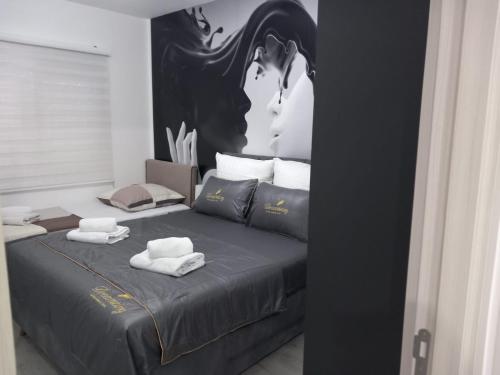 a bedroom with a bed with towels on it at Ulcinj Apartments in Ulcinj