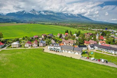an aerial view of a village with mountains in the background at Penzión Čerešňový Sad & Wellness in Vysoké Tatry