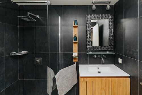 W łazience znajduje się umywalka i lustro. w obiekcie Villa Clara, Résidence face à l'océan et au golf de Chiberta w mieście Anglet