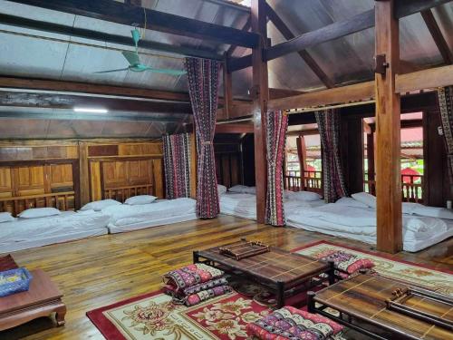 a large room with three beds and a table at Trường Anh Homestay Hà Giang in Ha Giang
