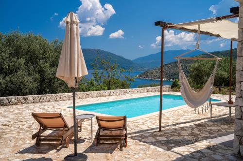 a villa with a swimming pool and a hammock at Villa Kandia in Ayia Evfimia