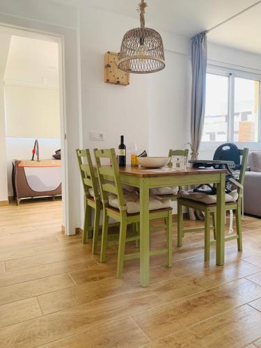 a dining room with a green table and chairs at Ocean View Luxury Las Americas in Playa de las Americas