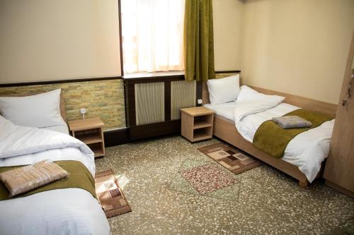 a room with two beds and a window at ASA Hotel in Yerevan