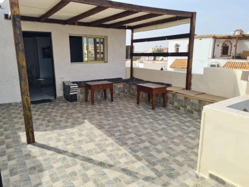 a patio with two wooden tables on top of a house at Hurghada, mubark6 in Hurghada