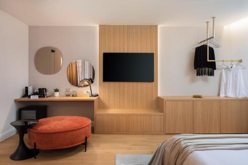a bedroom with a bed and a tv on a wall at Golden Gate Luxury Rooms - Unique UNESCO Location in Split