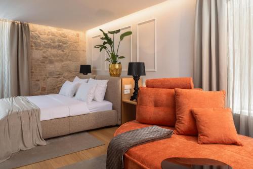 a hotel room with a bed and a couch at Golden Gate Luxury Rooms - Unique UNESCO Location in Split
