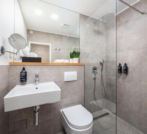a bathroom with a toilet and a sink and a shower at Golden Gate Luxury Rooms - Unique UNESCO Location in Split