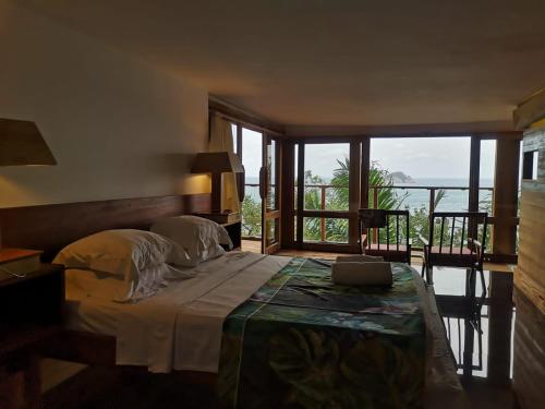 a bedroom with a bed with a view of the ocean at Takina house in Santana