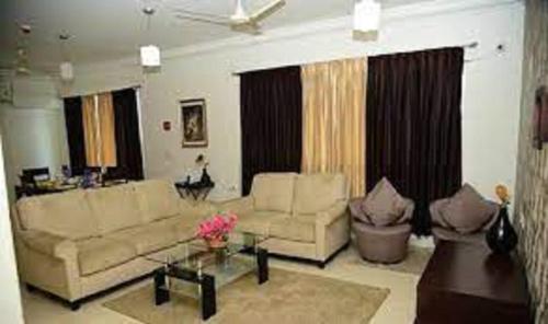 ein Wohnzimmer mit 2 Sofas und einem Tisch in der Unterkunft Oragadam Rooms By Actisai in Oragadam
