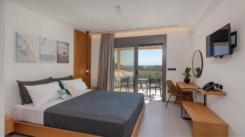 a bedroom with a bed and a desk and a television at Brisot in Galatas