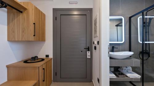 a bathroom with a door leading to a sink at Brisot in Galatas