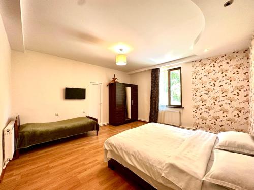 a bedroom with a large bed and a window at Guesthouse Mtkvari in Nak'alak'evi
