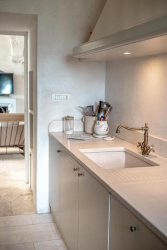 a kitchen with a sink and a counter top at Masseria Pavone in Martina Franca