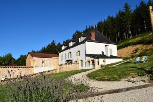 a large white house on top of a hill at Le Domaine de la Source in Chauffailles