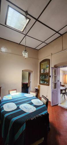 a bedroom with a large bed with a blue blanket at Heath Cote in Ooty