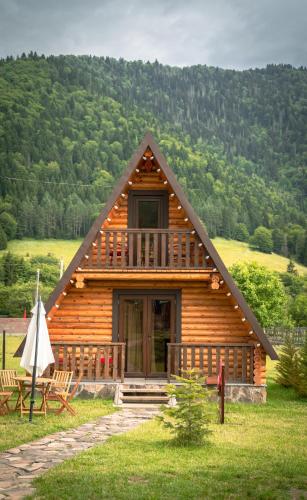 a log cabin with a porch and a balcony at Eco House Borjomi in Borjomi