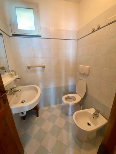 a bathroom with a toilet and a sink at Villaggio Smeraldo in Moneglia