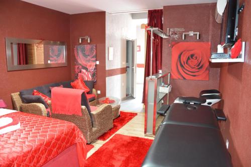 a red room with a bed and a salon at Sobe apartmani Zagreb SAZ in Zagreb