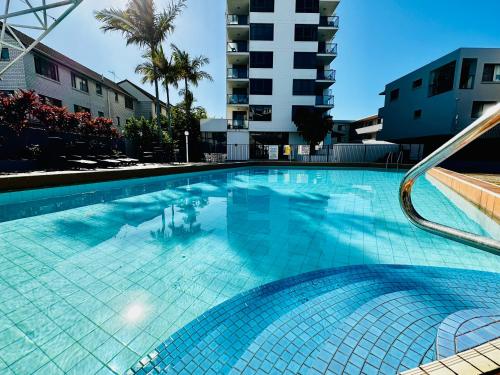Una gran piscina azul en un edificio. en Ocean View Apartments at the heart of Gold Coast, en Gold Coast