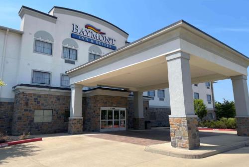 a building with a sign on the front of it at Baymont by Wyndham College Station in College Station