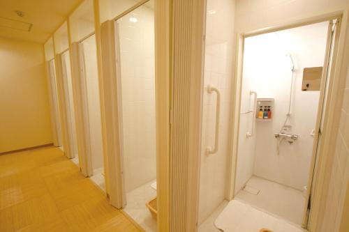 a bathroom with a shower and a walk in showeroser at HEARTS Capsule Hotel & Spa Nakasu -Male only- in Fukuoka