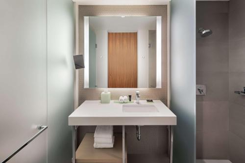 a bathroom with a white sink and a mirror at Hyatt Centric The Loop Chicago in Chicago