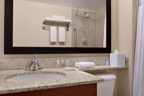 a bathroom with a sink and a shower at Days Inn & Suites by Wyndham Sherwood Park Edmonton in Sherwood Park