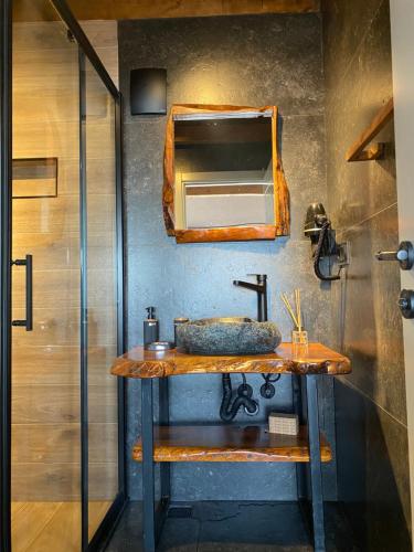 a bathroom with a sink and a mirror at Lavinya Suit Bungalov in Rize