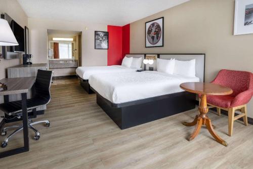 a hotel room with a bed and a table and chairs at Ramada by Wyndham Rome - Verona in Rome