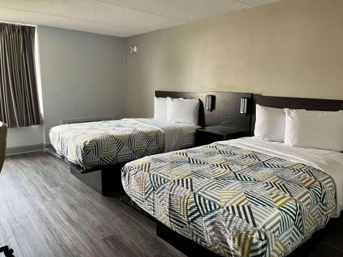 a hotel room with two beds and a window at Motel 6 Rock Hill SC in Rock Hill