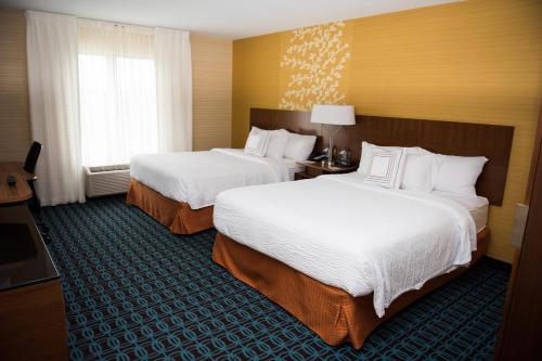 a hotel room with two beds and a window at Fairfield Inn & Suites by Marriott Moncton in Moncton