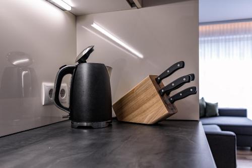 a black coffee pot sitting on a kitchen counter at DAS MORITZ- Fine Living Apartments in Nauders