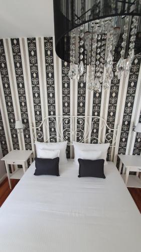 a white bed with two pillows in a room at Villa Hvar II in Ivan Dolac