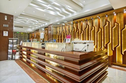 a restaurant with wooden walls and a counter at Hotel Sarina in Dhaka