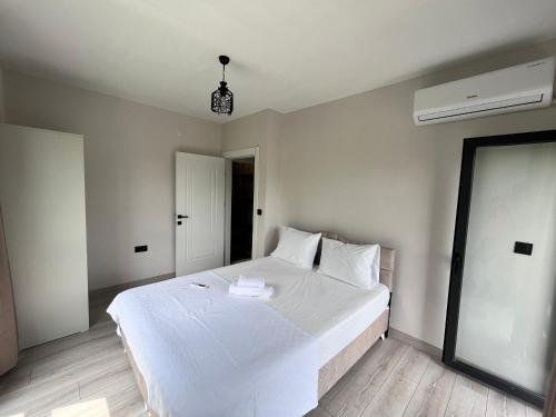 a bedroom with a large white bed in it at Noğa Suit Apart in Pazar