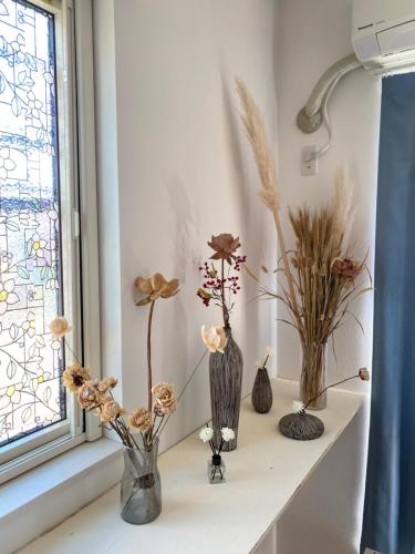 a group of vases sitting on a shelf next to a window at Arts Candy Sapporo-Villa Nakajima in Sapporo