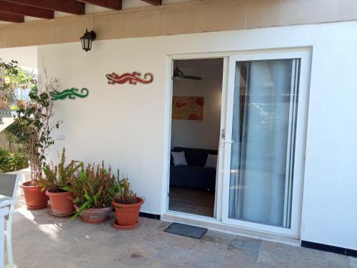 a sliding glass door to a patio with potted plants at Cap de Mar in Alcudia