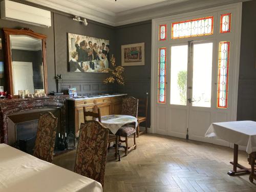 a dining room with a table and a mirror at La Villa Celine in Saint-Laurent-de-la-Cabrerisse